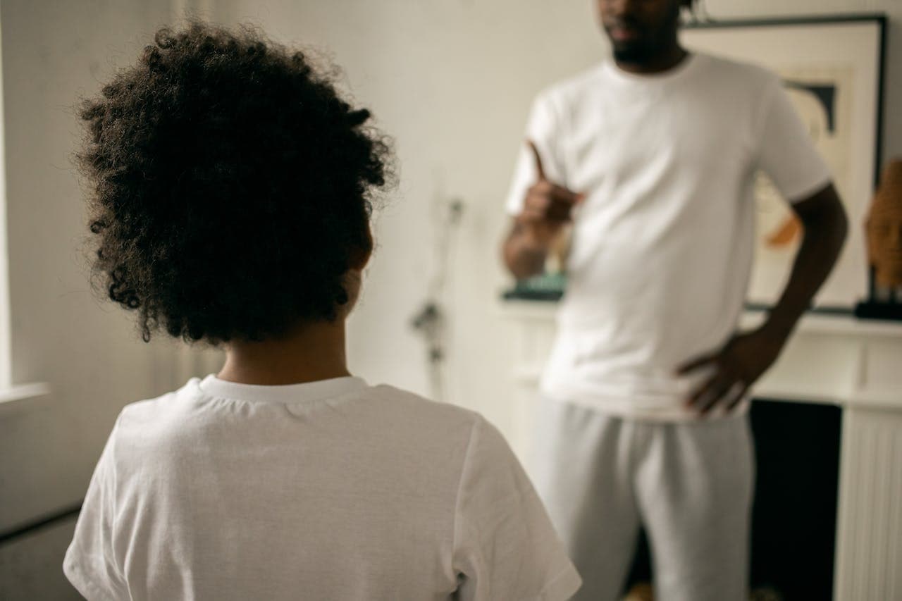 Father correcting child