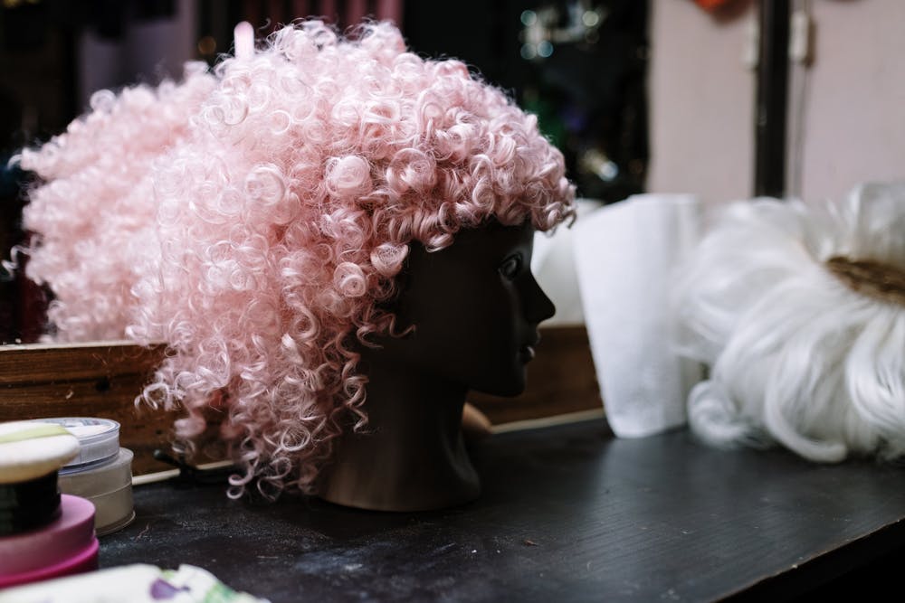Pink wig on dressing table