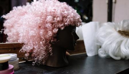 Pink wig on dressing table